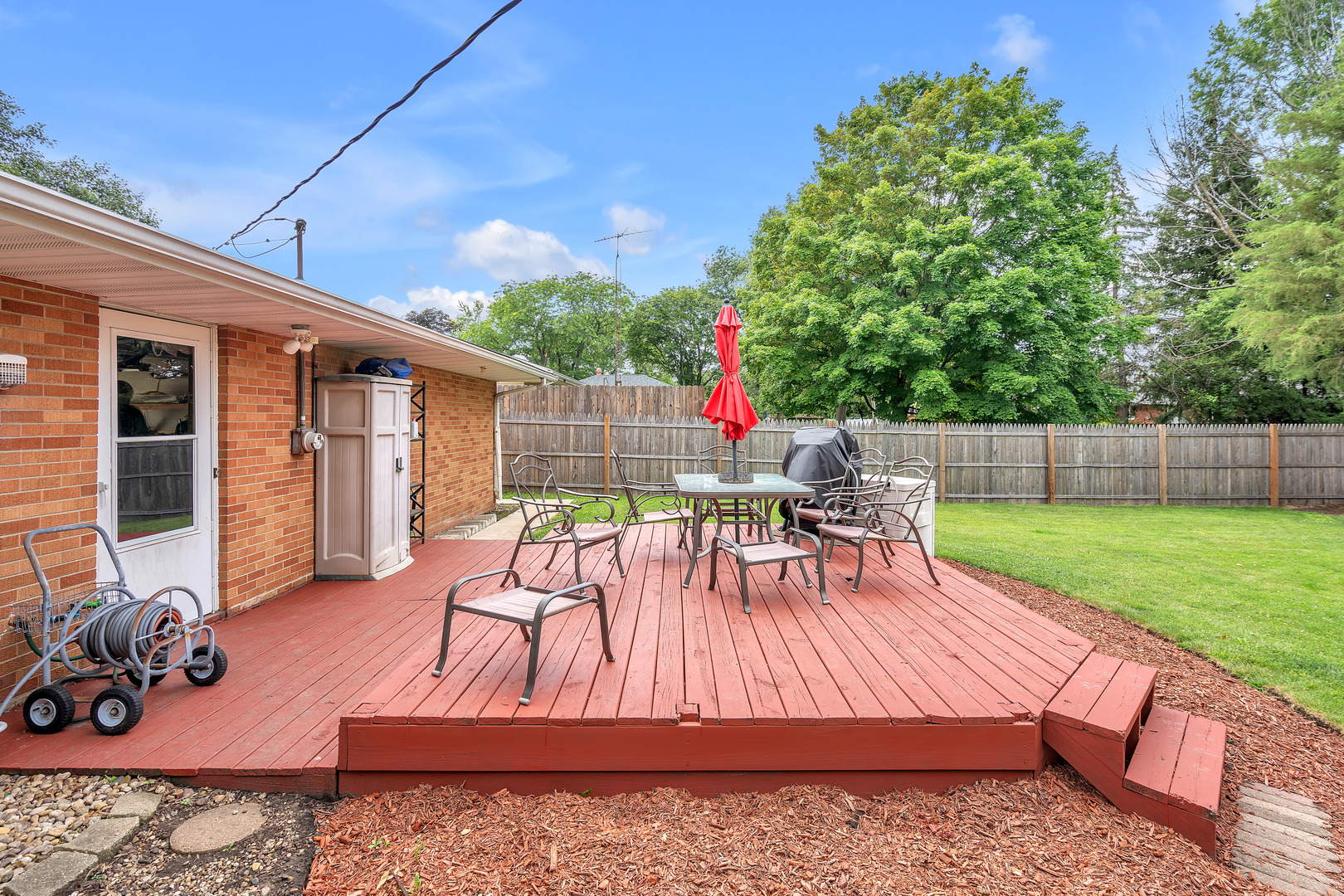 312 Wilmac Street Dwight, IL 60420 - Photo 16 of 26 a view of backyard with seating space and trees in the background