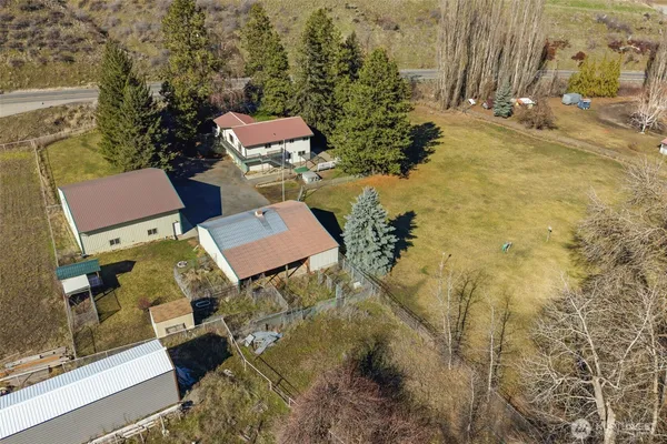 a view of a house with a yard and sitting area