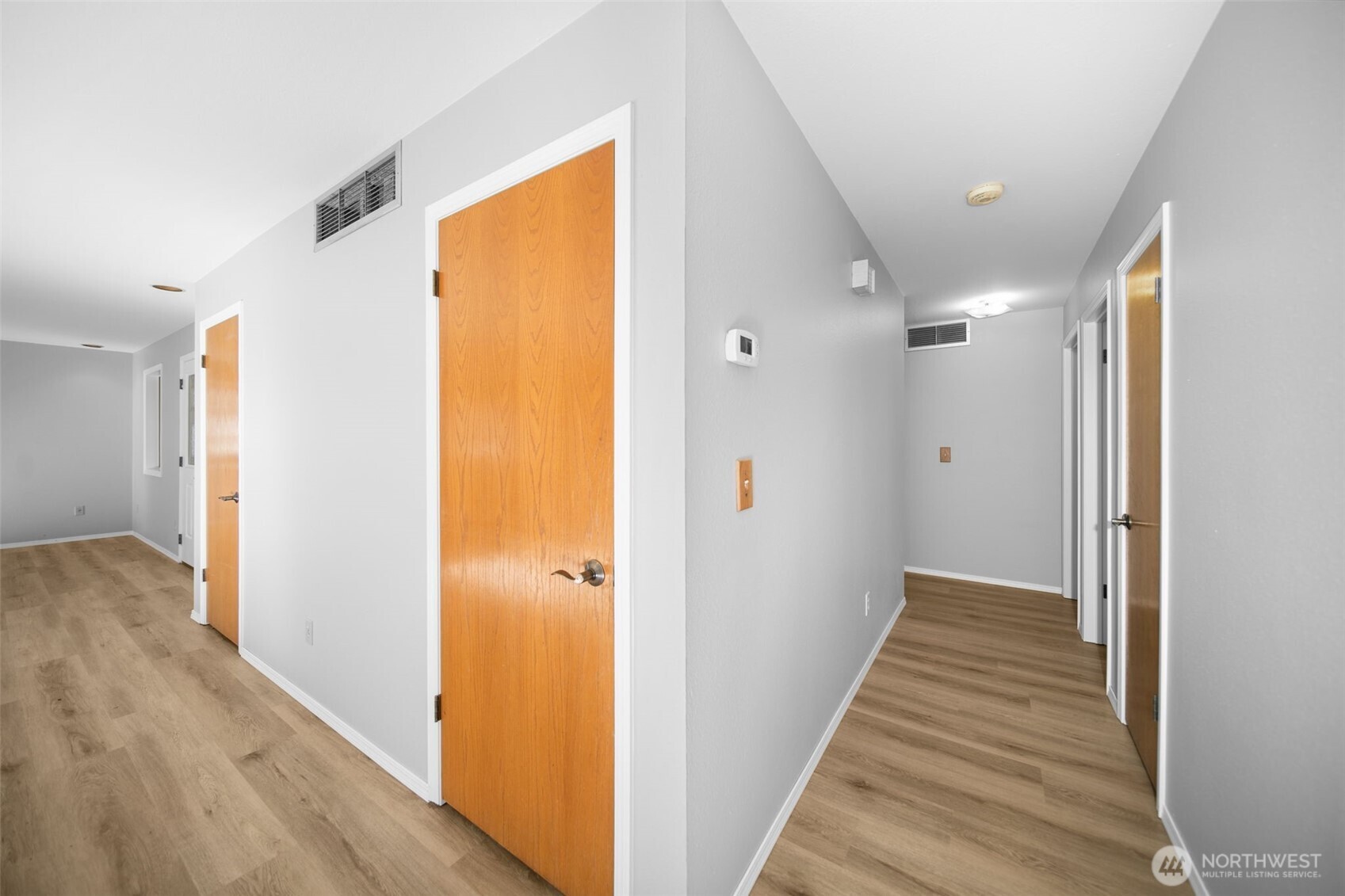 4195 Squilchuck Road Wenatchee, WA 98801 - Photo 11 of 39 a view of a hallway with wooden floor and a bathroom