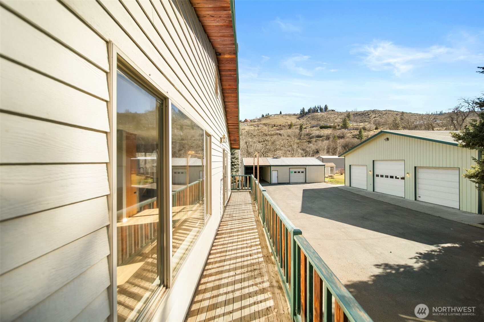 4195 Squilchuck Road Wenatchee, WA 98801 - Photo 7 of 39 a view of a balcony with wooden floor and a floor to ceiling window