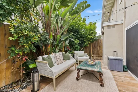 a backyard of a house with table and chairs