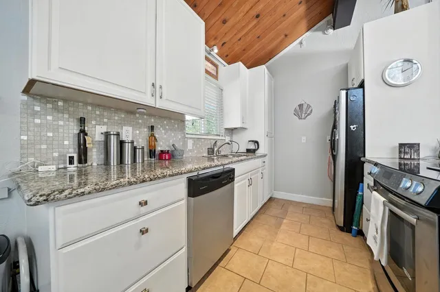 a kitchen with stainless steel appliances granite countertop a sink and cabinets