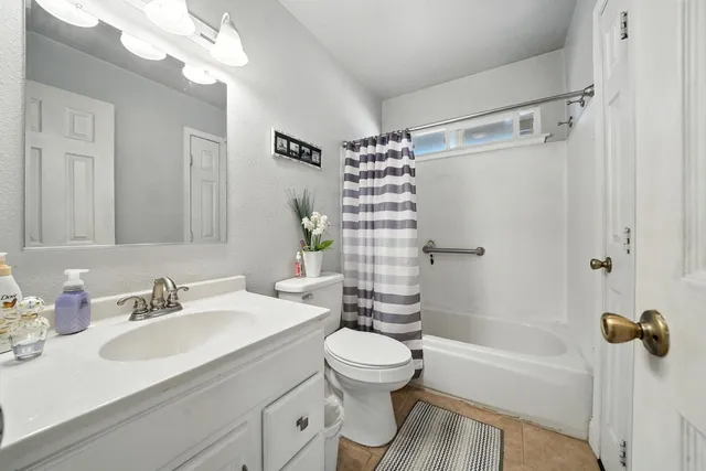 a spacious bathroom with a sink and a mirror