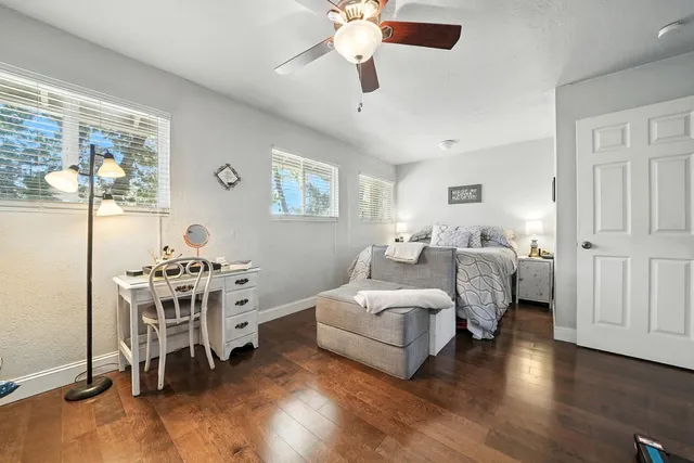 a bedroom with bed and a potted plant