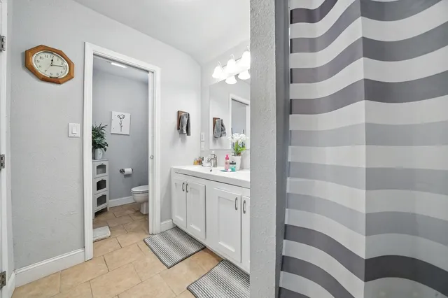 a living room with furniture and a book shelf