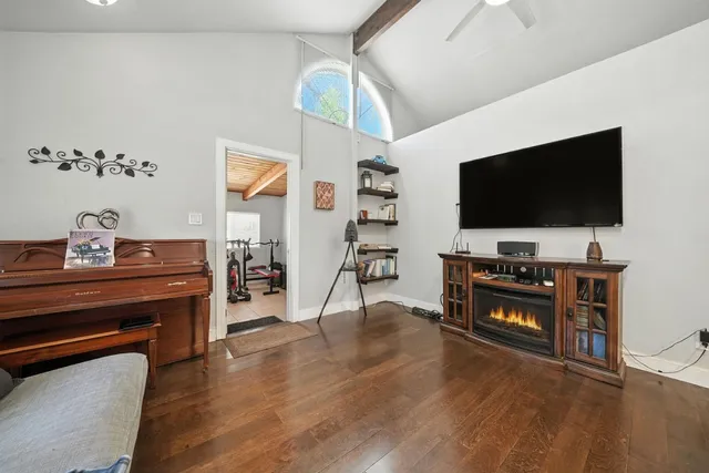 a room with gym equipment and a flat screen tv