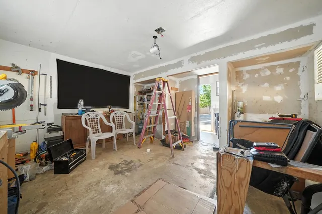 a front view of a house with a yard covered with snow