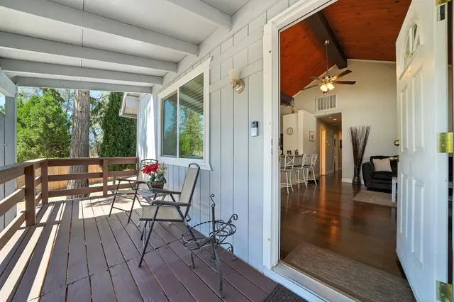 a view of a patio with wooden floor and outdoor seating