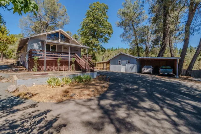 a view of a house with a yard and sitting area