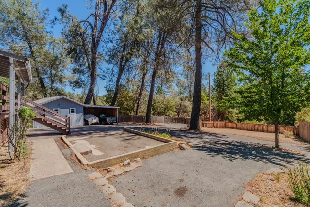 an aerial view of a house with a yard and a large tree
