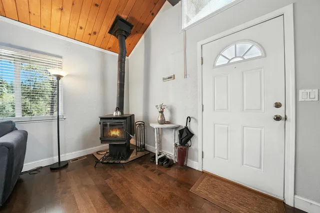 a view of a workspace with wooden floor and windows