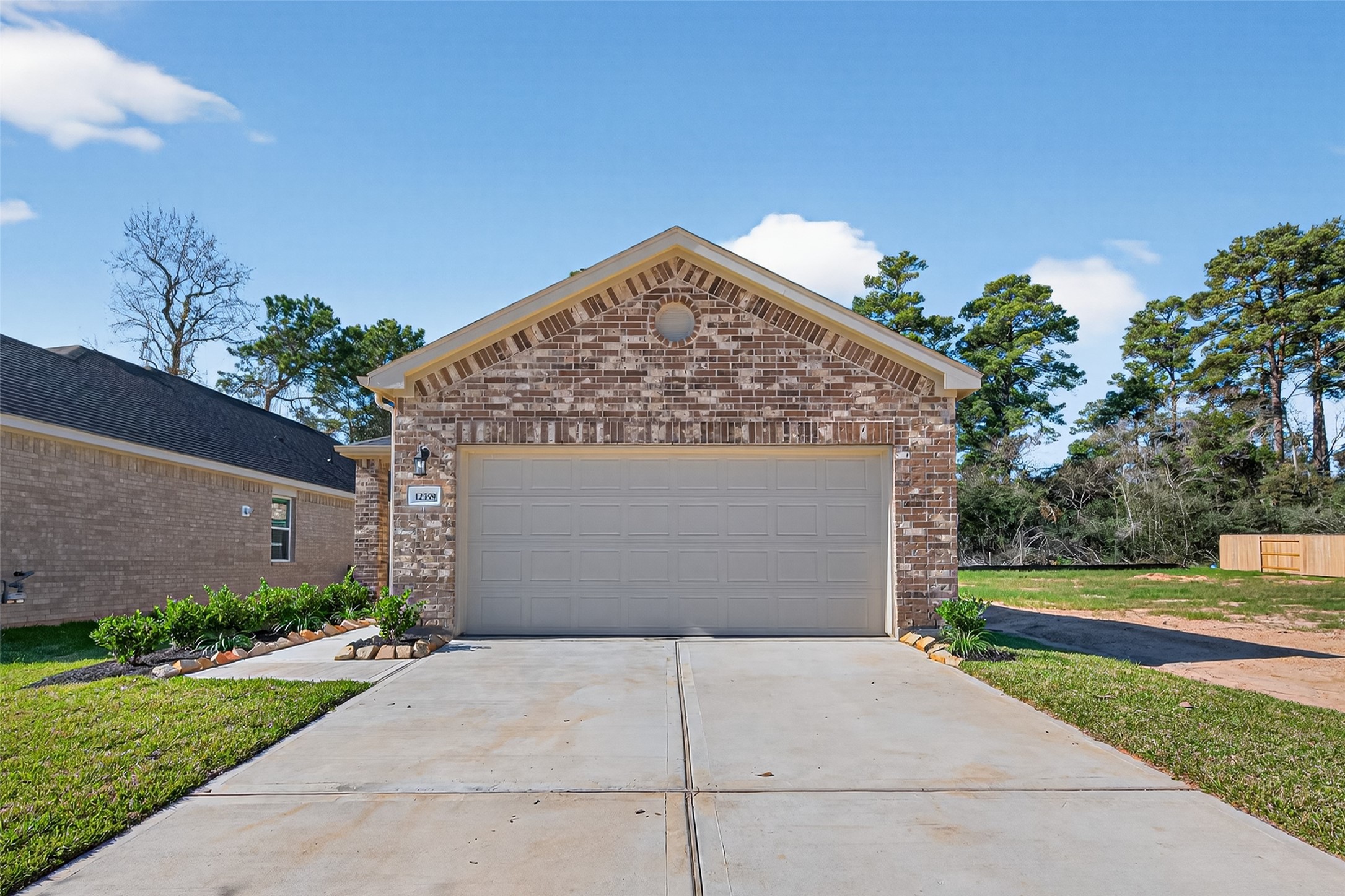 12359 Sunset Canyon Way Willis, TX 77318 - Photo 1 of 35 a front view of a house with a yard and garage