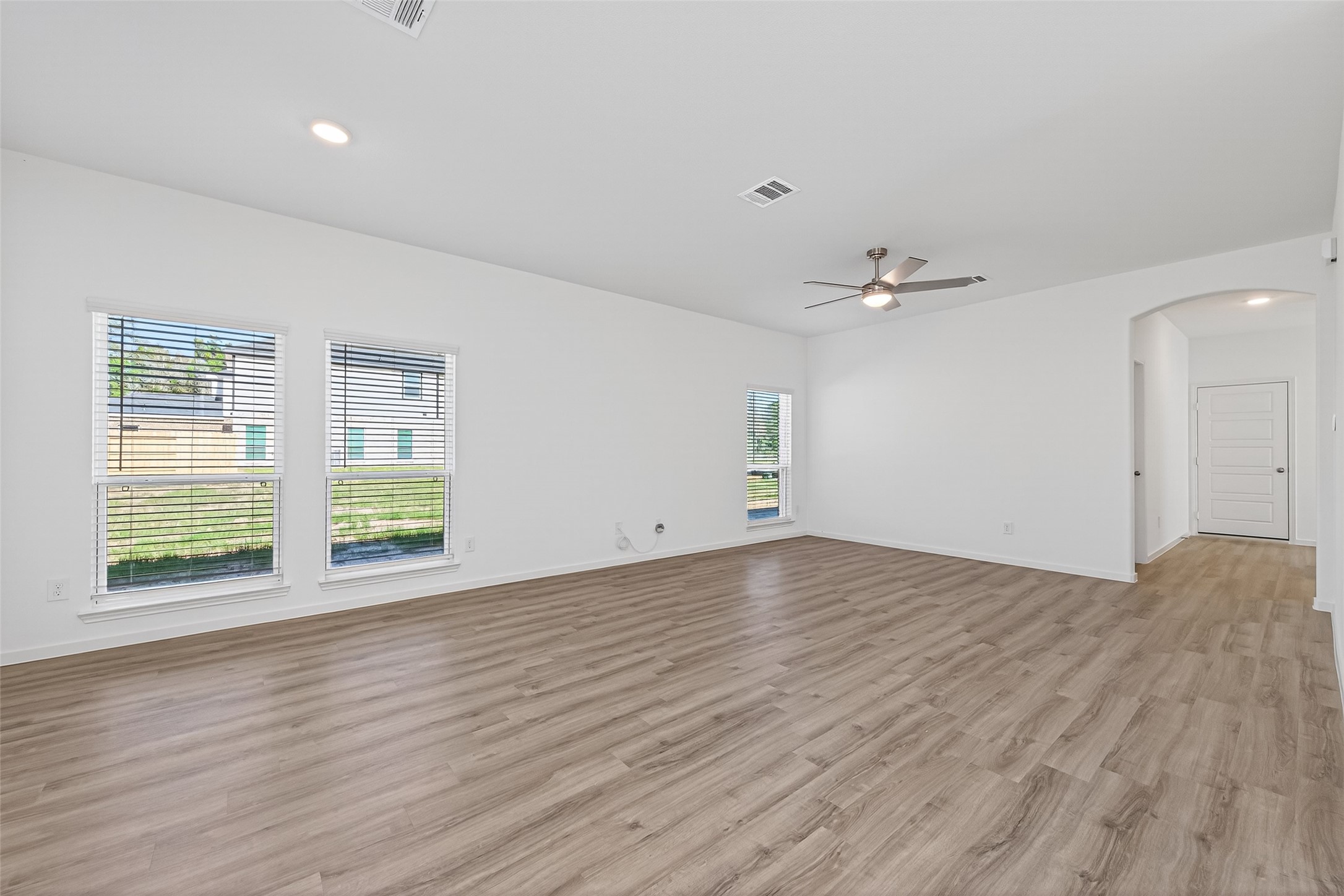 12359 Sunset Canyon Way Willis, TX 77318 - Photo 11 of 35 a view of an empty room with wooden floor and a window