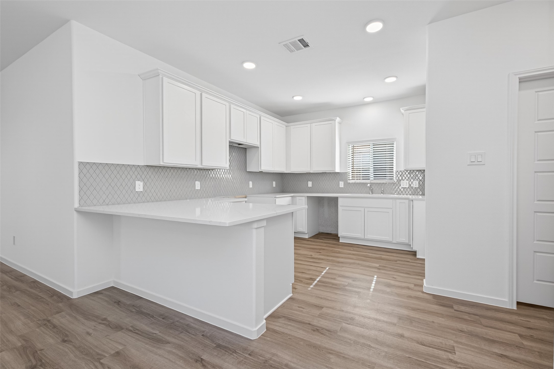 12359 Sunset Canyon Way Willis, TX 77318 - Photo 12 of 35 a kitchen with wooden floors a sink stainless steel appliances and cabinets
