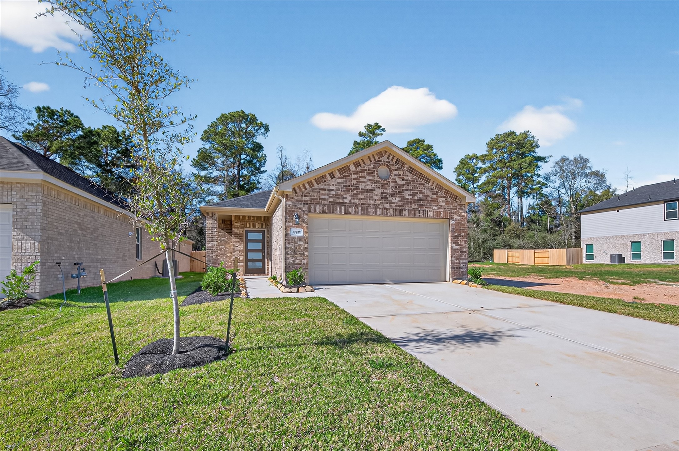 12359 Sunset Canyon Way Willis, TX 77318 - Photo 2 of 35 a front view of a house with a yard and garage