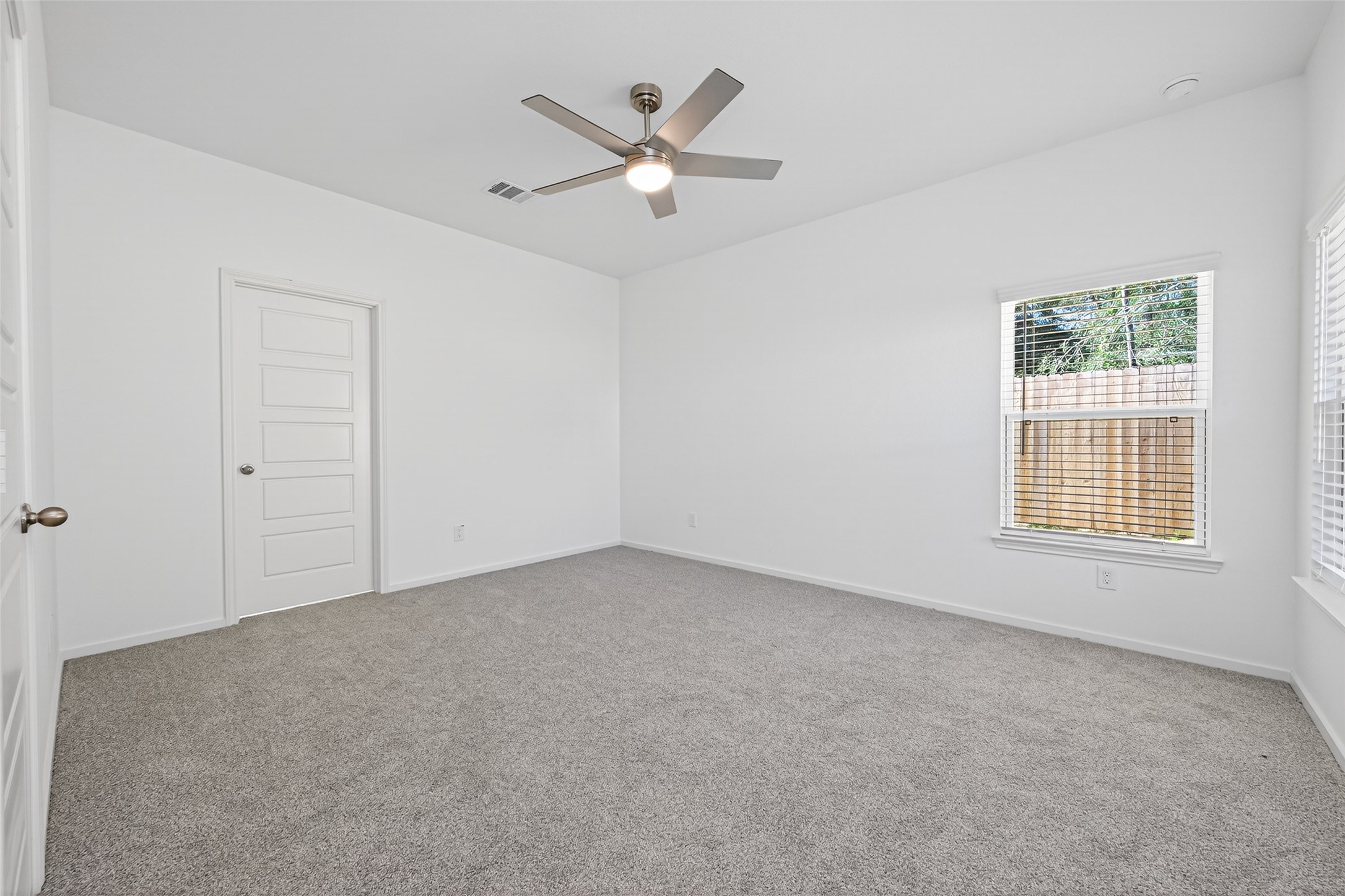 12359 Sunset Canyon Way Willis, TX 77318 - Photo 21 of 35 an empty room with ceiling fan and window