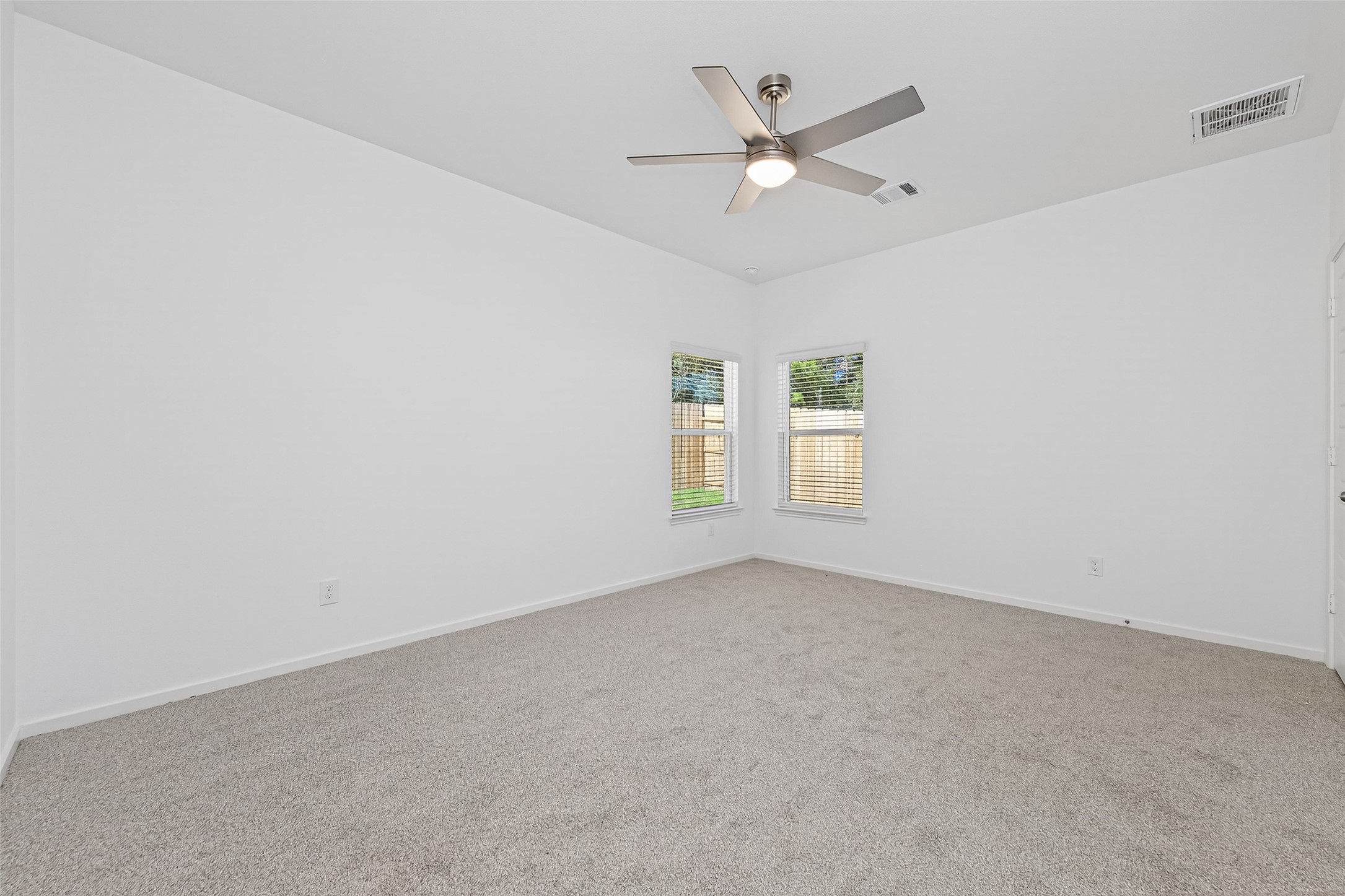 12359 Sunset Canyon Way Willis, TX 77318 - Photo 23 of 35 an empty room with a window and a ceiling fan