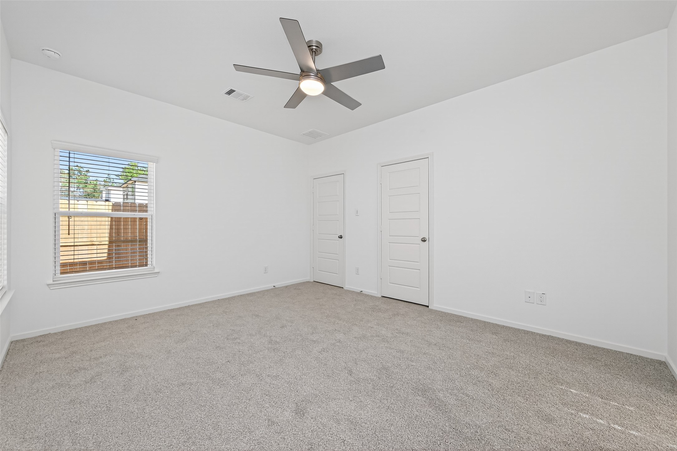 12359 Sunset Canyon Way Willis, TX 77318 - Photo 24 of 35 an empty room with a window and a fan