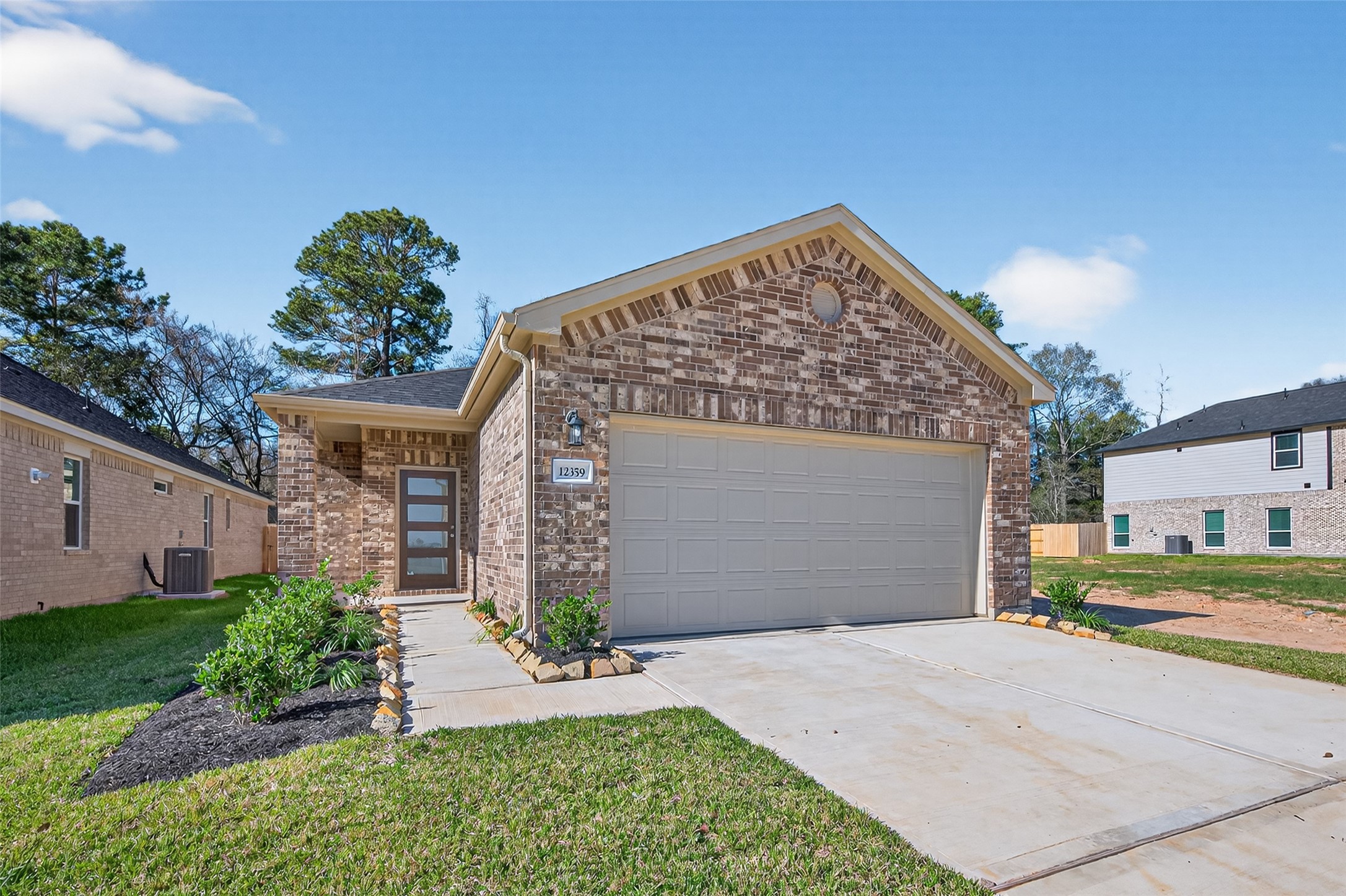 12359 Sunset Canyon Way Willis, TX 77318 - Photo 3 of 35 a front view of a house with a yard and garage