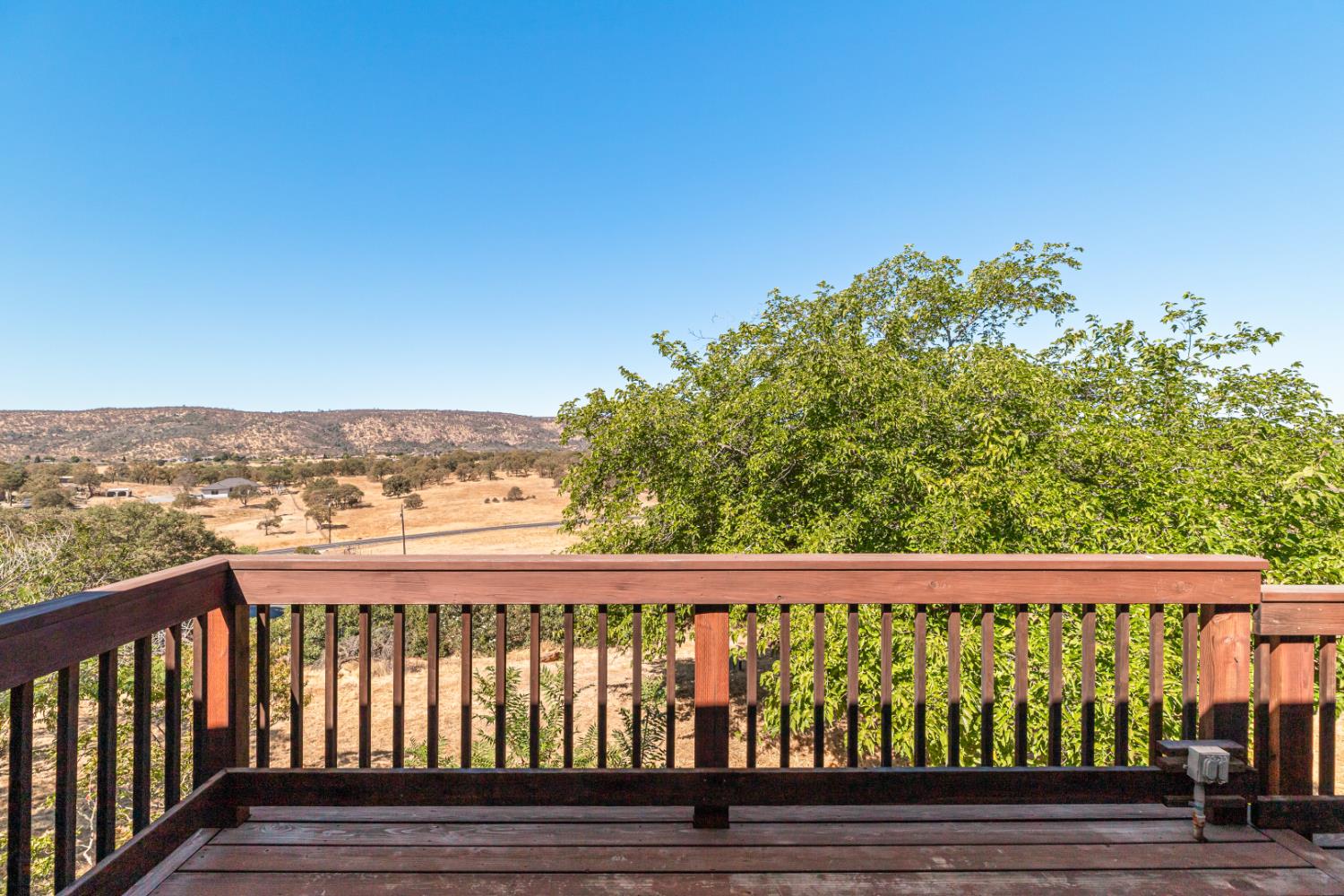 2512 Quail Hill Road Copperopolis, CA 95228 - Photo 16 of 70 a view of a balcony with wooden fence