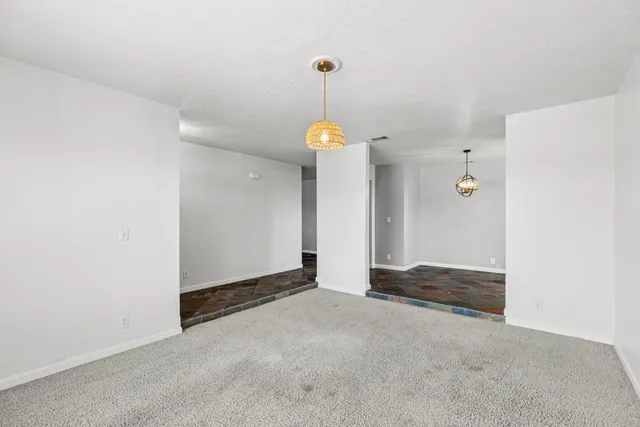 a view of a kitchen with a sink refrigerator and wooden floor