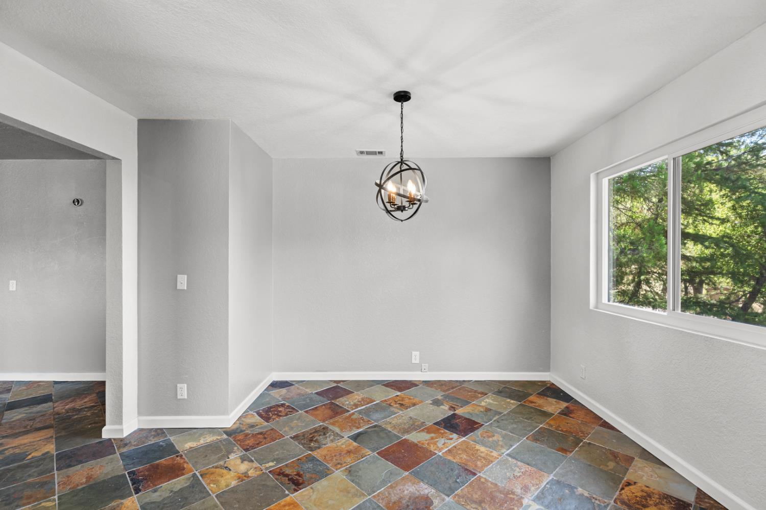 2512 Quail Hill Road Copperopolis, CA 95228 - Photo 22 of 70 a view of a room with a chandelier fan and windows