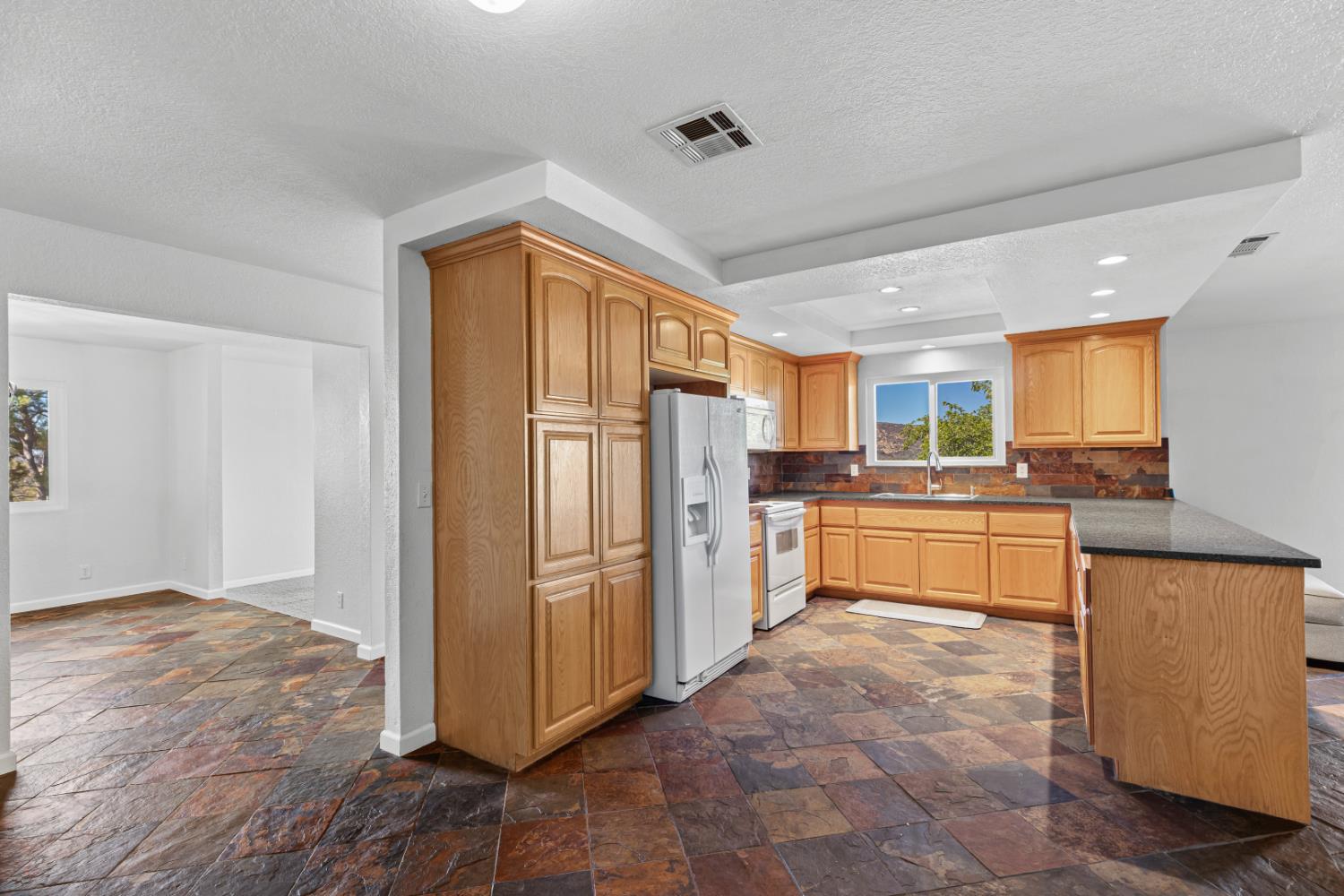 2512 Quail Hill Road Copperopolis, CA 95228 - Photo 26 of 70 a kitchen with stainless steel appliances granite countertop a refrigerator and a stove top oven