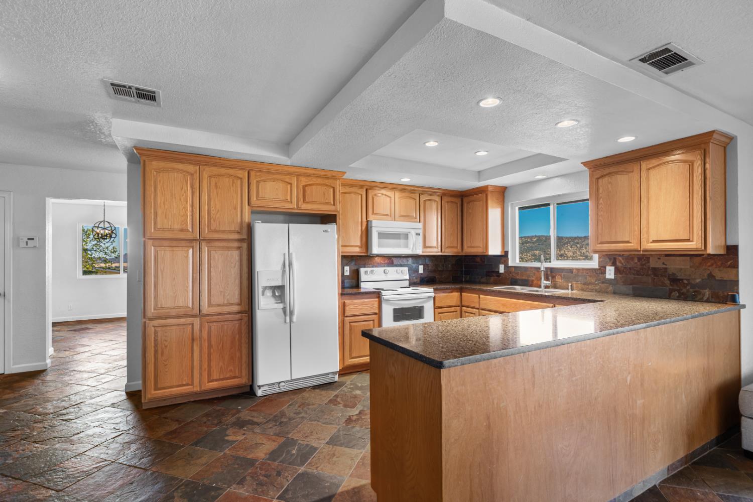 2512 Quail Hill Road Copperopolis, CA 95228 - Photo 28 of 70 a view of a kitchen with a sink refrigerator and wooden floor