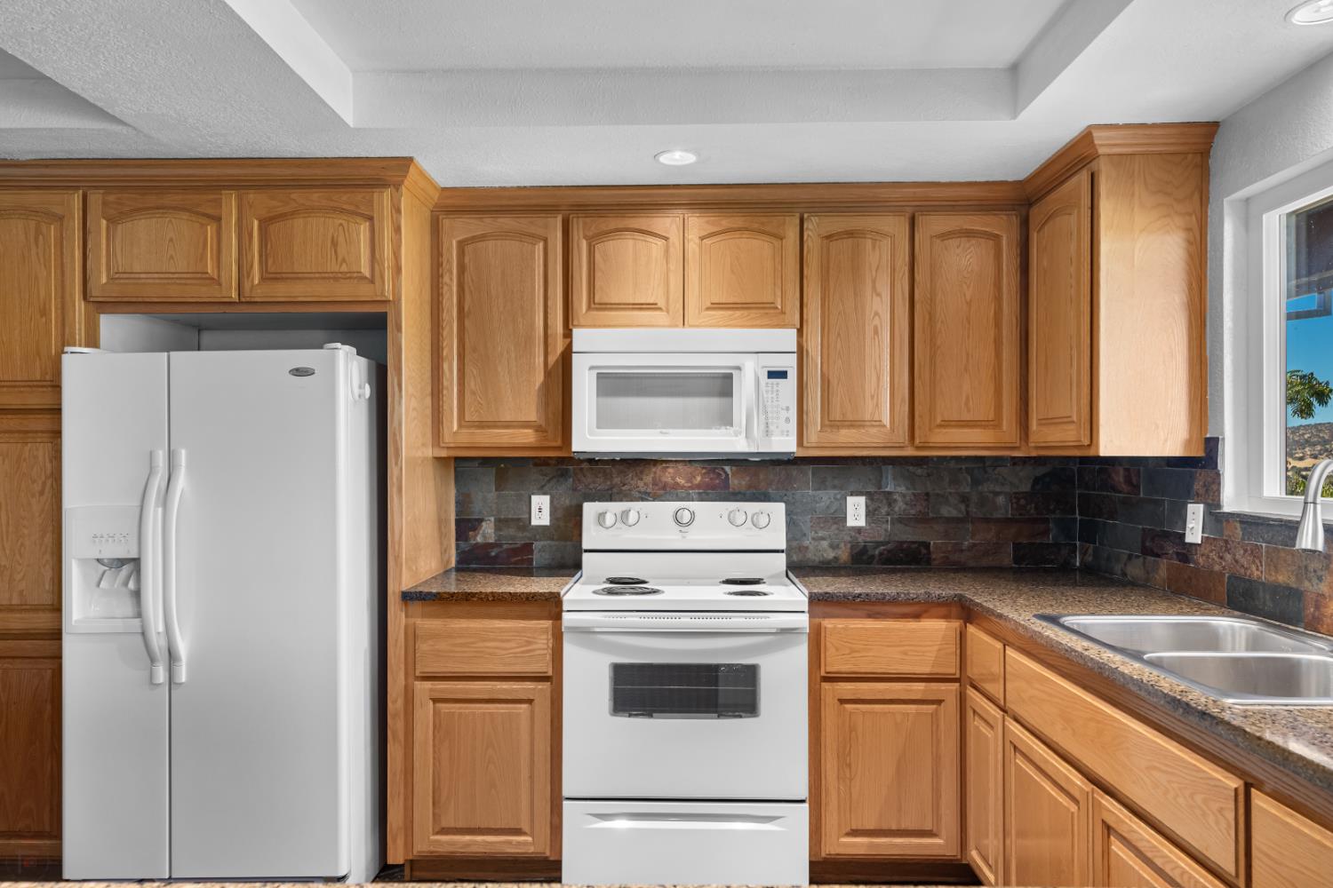 2512 Quail Hill Road Copperopolis, CA 95228 - Photo 29 of 70 a kitchen with stainless steel appliances granite countertop a refrigerator sink and cabinets