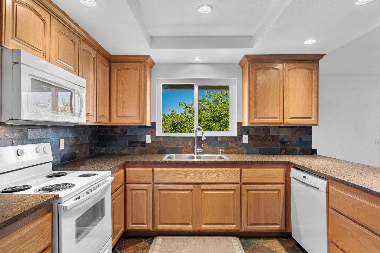 2512 Quail Hill Road Copperopolis, CA 95228 - Photo 30 of 70 a kitchen with stainless steel appliances granite countertop a sink stove and cabinets