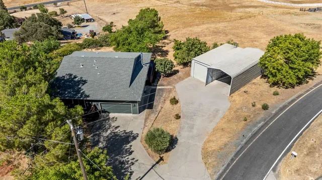 an aerial view of a house with a yard and garden