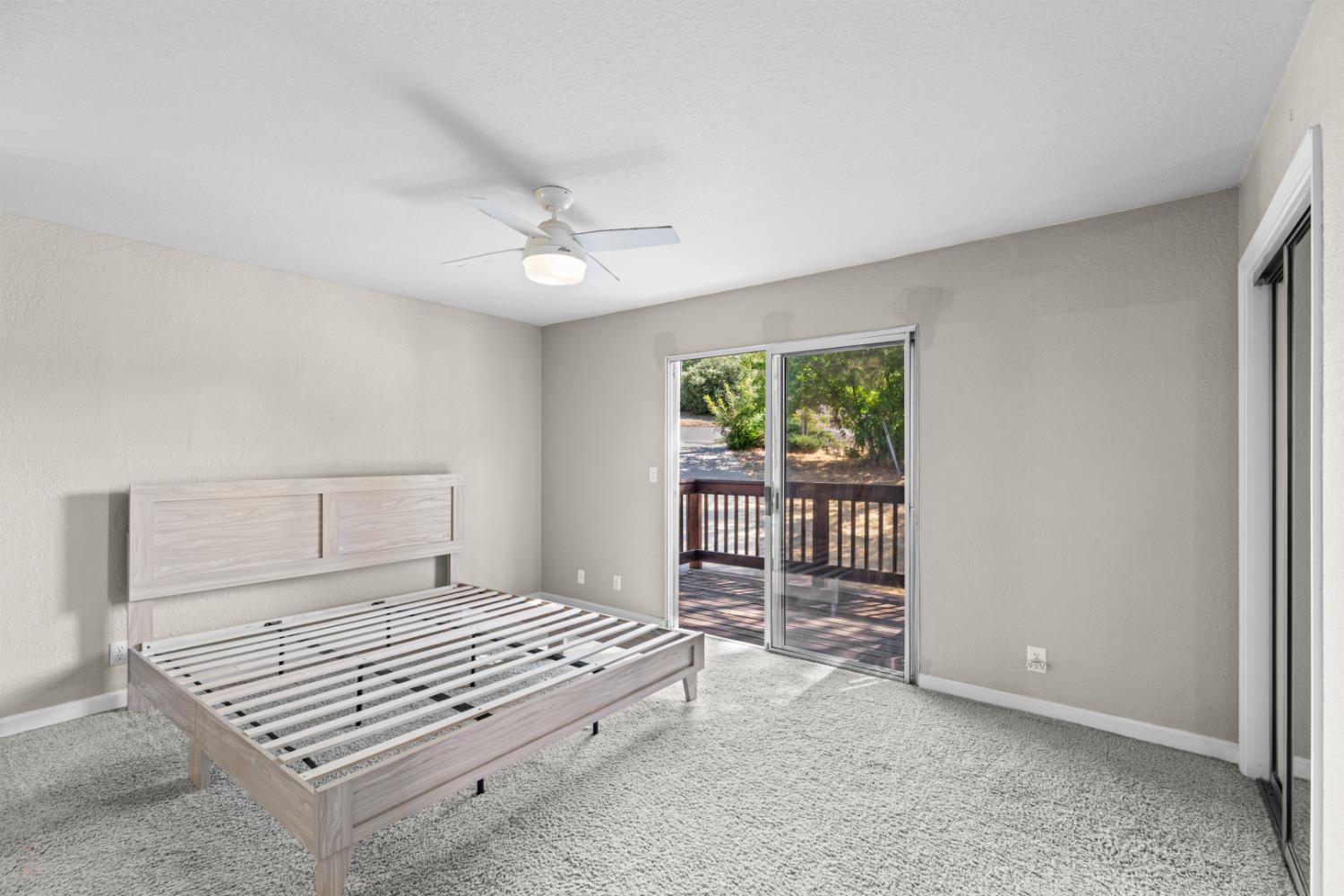 2512 Quail Hill Road Copperopolis, CA 95228 - Photo 41 of 70 a bedroom with a bed and a chandelier