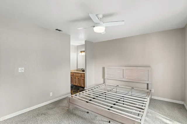 an aerial view of residential houses with outdoor space and trees