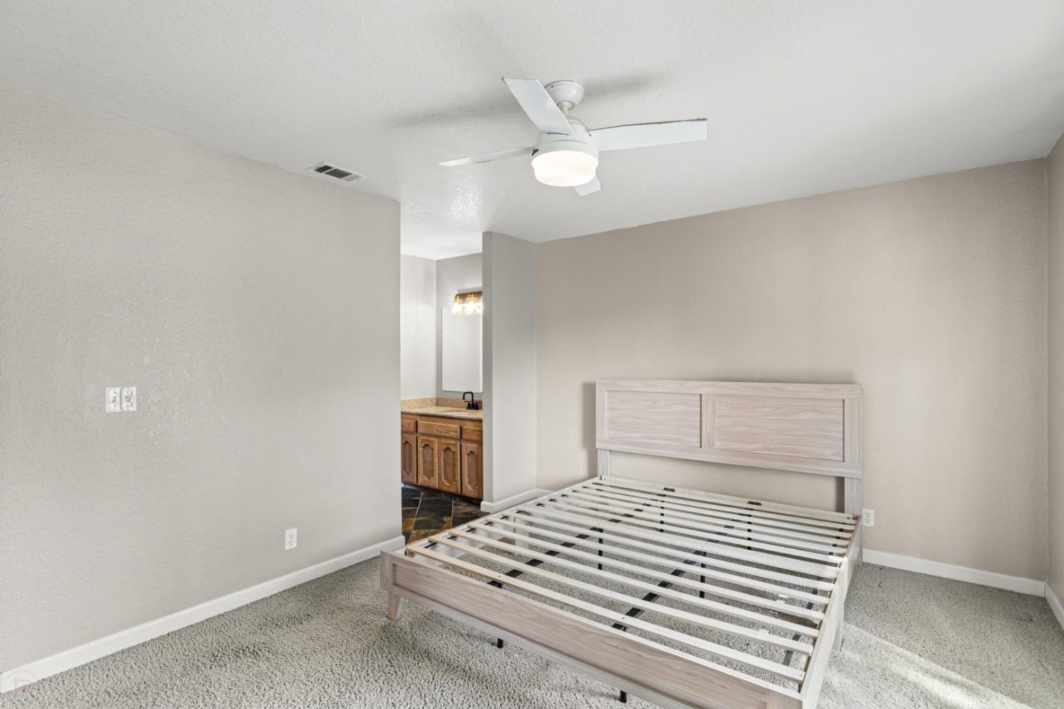 2512 Quail Hill Road Copperopolis, CA 95228 - Photo 45 of 70 a bedroom with a bed and a ceiling fan