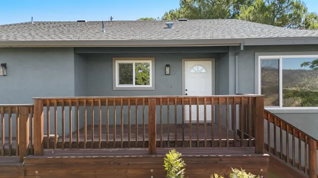 a view of a hallway with wooden floor and closet