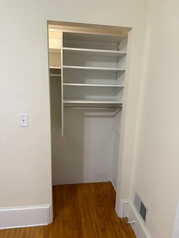 a view of walk in closet with empty racks