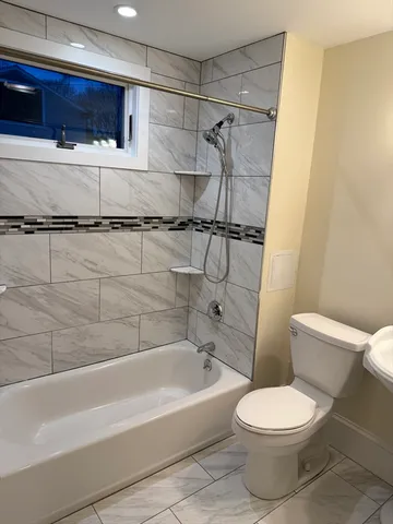 a bathroom with a toilet and a bathtub
