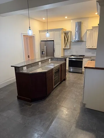 a kitchen with stainless steel appliances granite countertop a sink and a stove