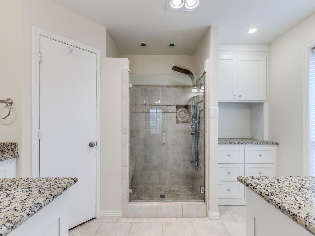 4020 Morman Lane Addison, TX 75001 - Photo 19 of 31 a bathroom with a granite countertop shower a mirror and a sink