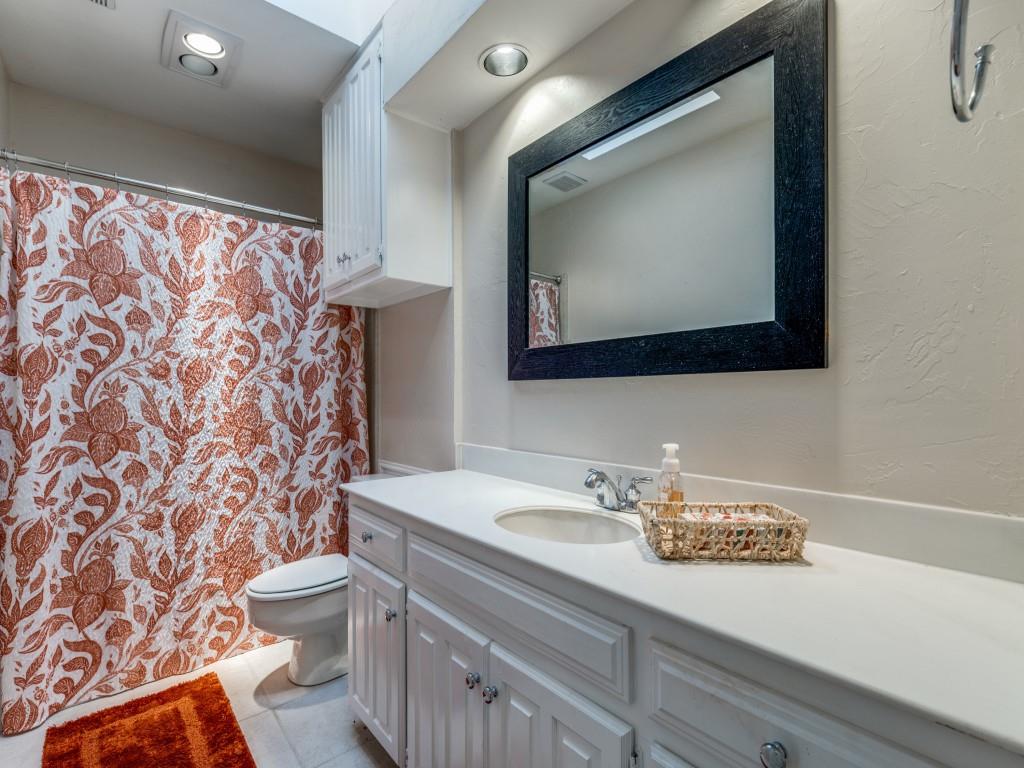 4020 Morman Lane Addison, TX 75001 - Photo 23 of 31 a bathroom with a sink a toilet and mirror