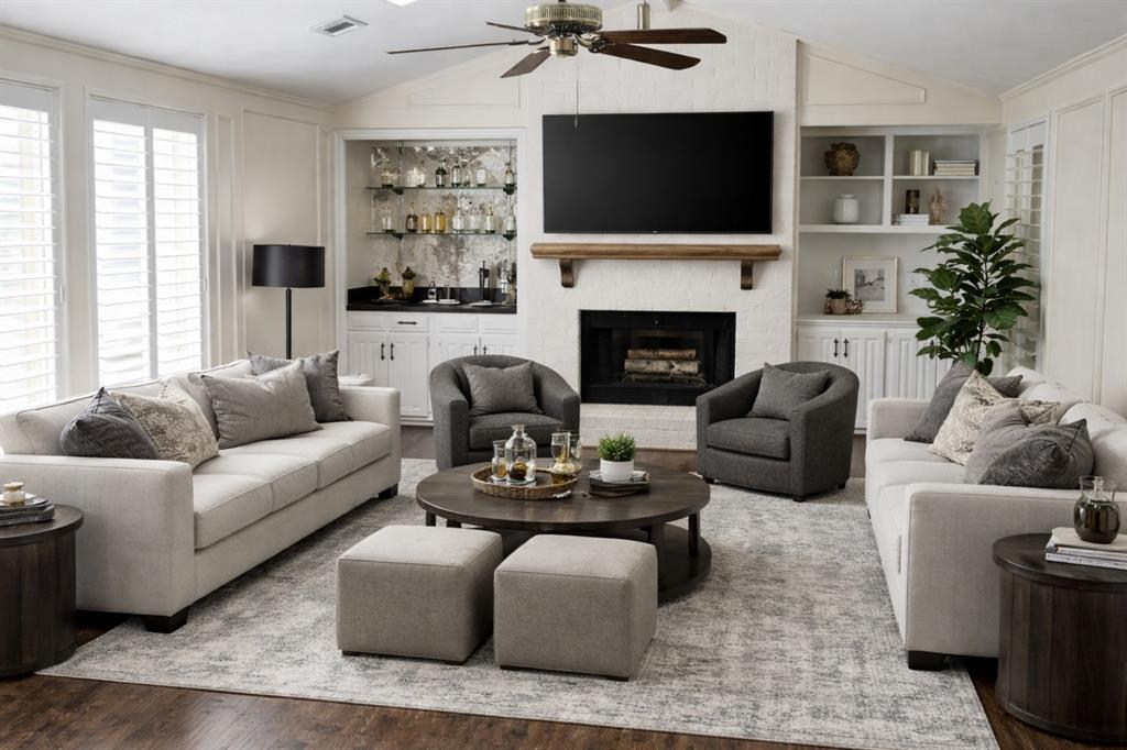 4020 Morman Lane Addison, TX 75001 - Photo 4 of 31 a living room with furniture a flat screen tv and a fireplace