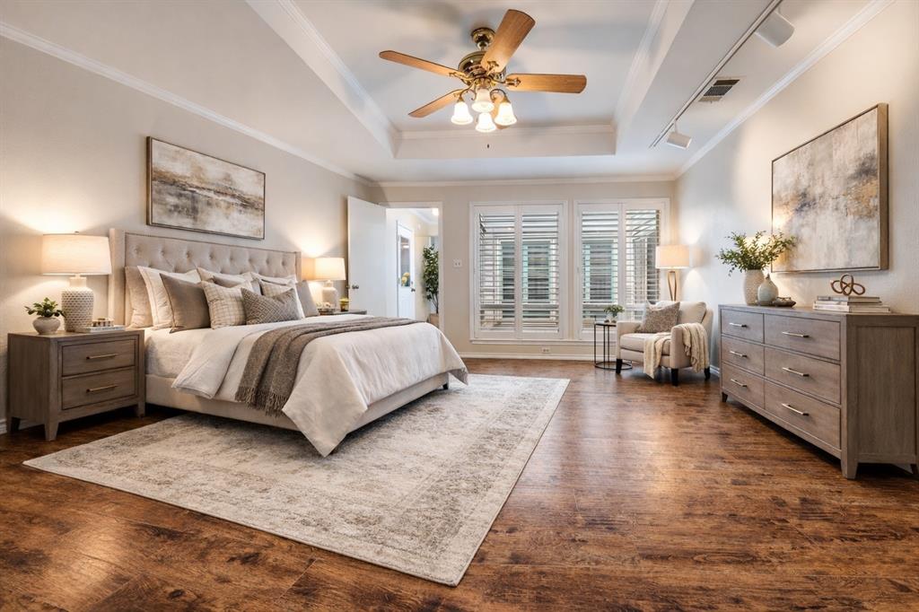 4020 Morman Lane Addison, TX 75001 - Photo 7 of 31 a spacious bedroom with a large bed and a chandelier