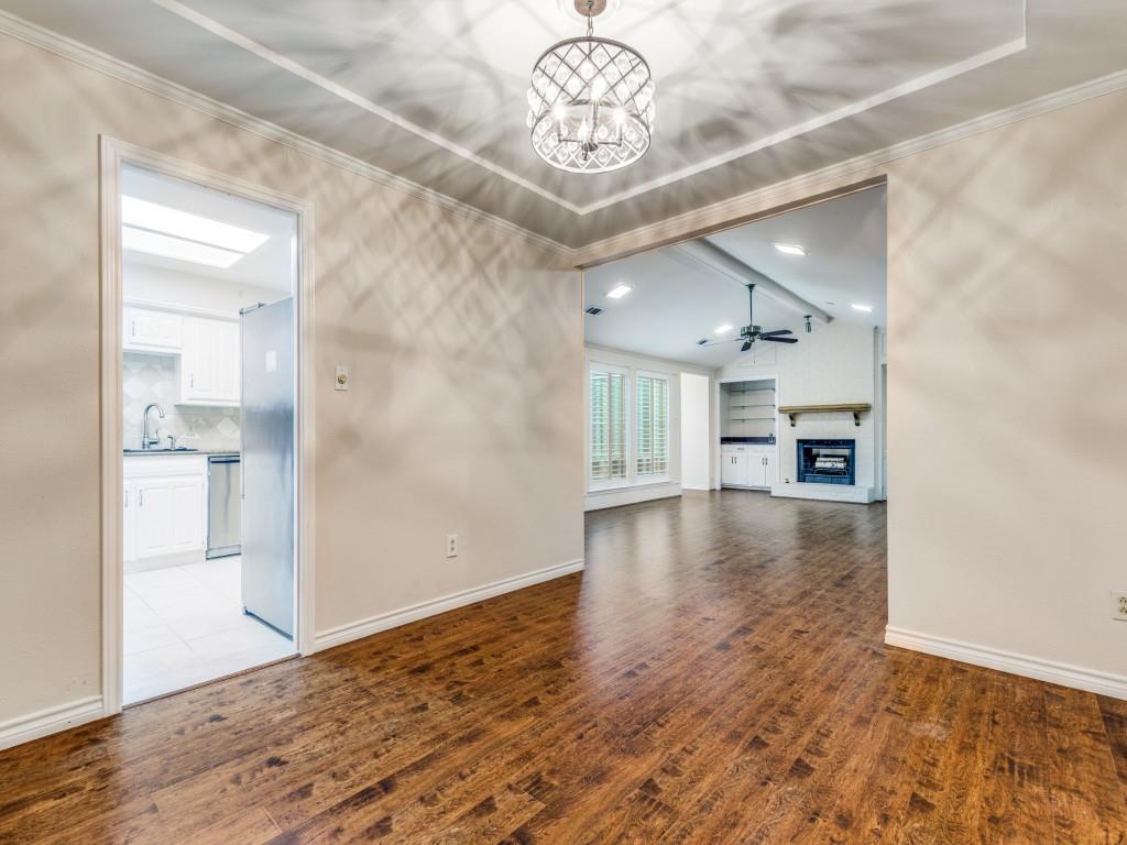 4020 Morman Lane Addison, TX 75001 - Photo 10 of 31 a view of empty room with wooden floor and kitchen view