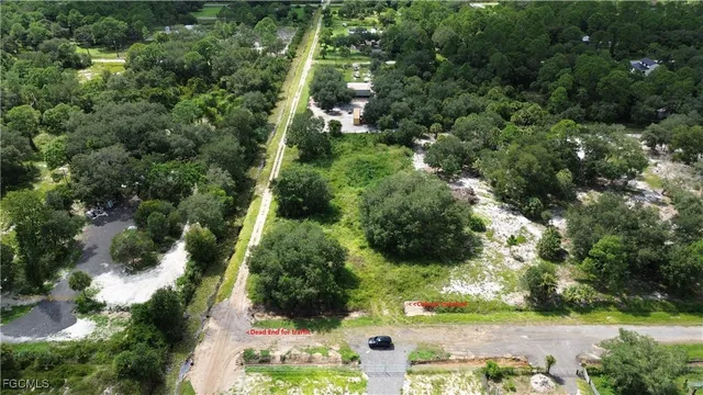 an aerial view of a house with yard