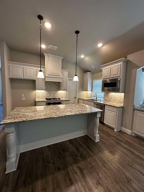 1217 Timber Grove Terrace Little Elm, TX 76227 - Photo 2 of 19 a large kitchen with a table chairs wooden floor and a sink
