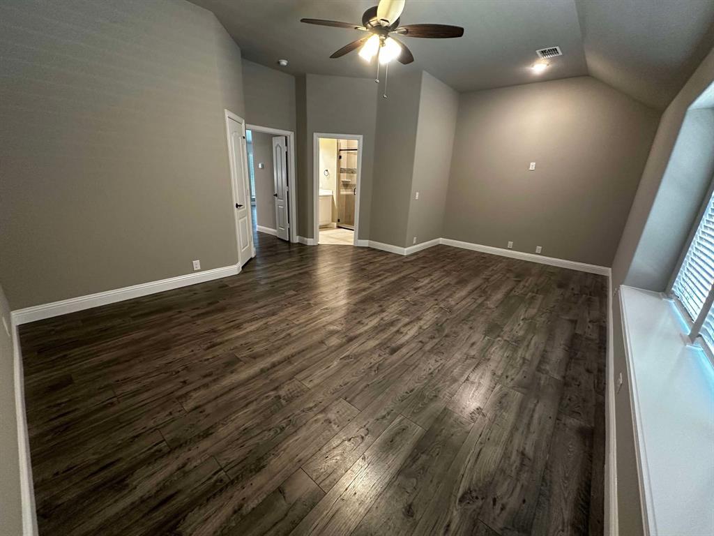 1217 Timber Grove Terrace Little Elm, TX 76227 - Photo 5 of 19 a view of an empty room with wooden floor and a ceiling fan