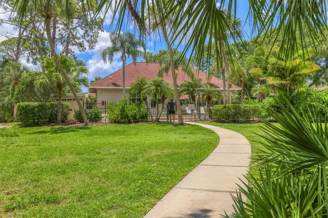 a view of yard with swimming pool and green space