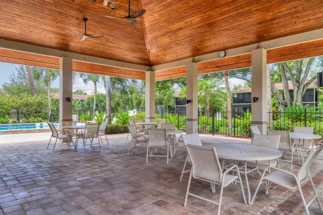 a view of a patio with table and chairs