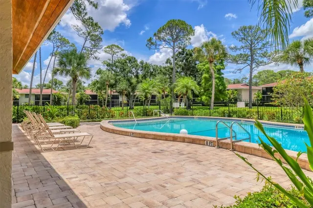 a view of backyard with swimming pool and green space