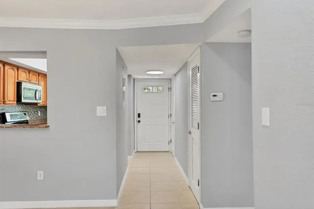 a view of a hallway with wooden floor and a living room